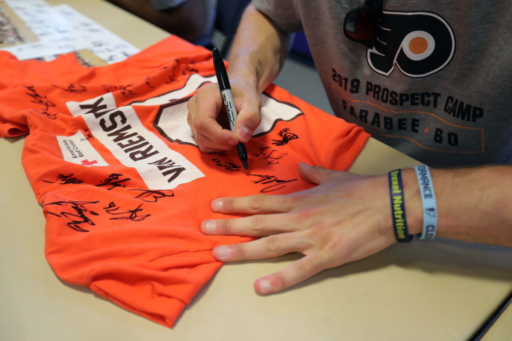 Philadelphia Flyers prospects sign autographs and play volleyball